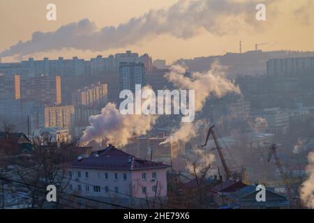 Urban landscape with smoke from heating systems. Vladivostok, Russia Stock Photo