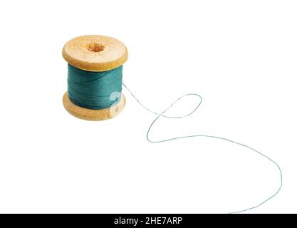 Sewing thread wooden spool of colors isolated on white. Wooden tube.  Old thread wooden spool. Stock Photo