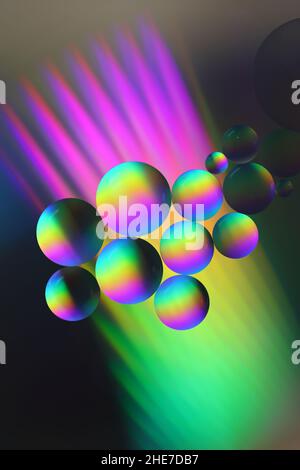 close-up of seemingly colourful oil droplets on a surface of water Stock Photo