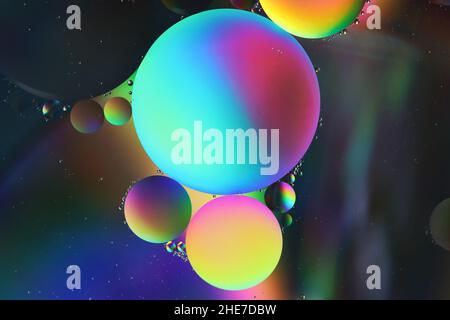 light and dark, large and small beautiful oil droplets float over a water surface Stock Photo