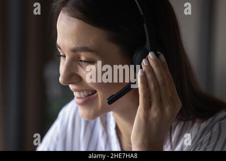 Happy call center office employee in headphones with microphone Stock Photo