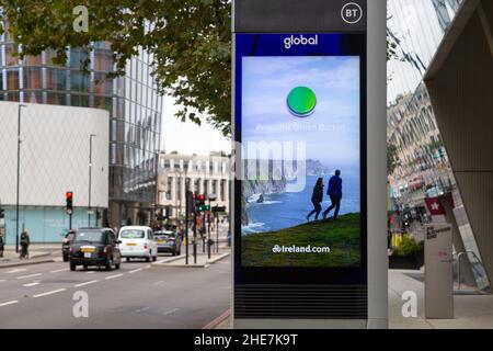 DOOH, digital out of home by Global and BT, Marketing electronic advertising street pavement signs, digital signage display, Ireland.com, london, uk Stock Photo