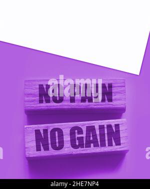 No Pain No Gain message written with wooden blocks on yellow. Business success concept. Stock Photo