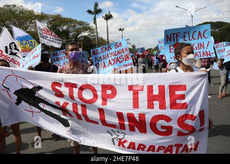Protesters carry signs during a protest to mark the 73rd International Human Rights Day at the University of the Philippines in Quezon City, Metro Manila. Thousands of activists from various groups rallied against the implementation of the controversial anti-terror law and alleged human rights violations, including attacks on media workers and alleged extrajudicial killings in President Duterte's crackdown against illegal drugs. Philippines. Stock Photo