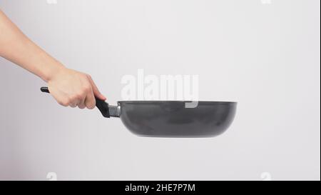 Cleaning Electric non stick pan. Hand on white background cleaning the non  stick pan with handy dish washing sponge which yellow color on the soft sid  Stock Photo - Alamy