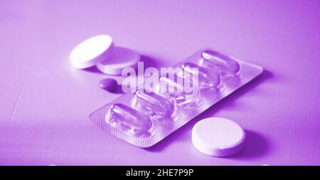 Pills, tabs and omega 6 evening primrose oil capsules. Healthcare concept. Stock Photo