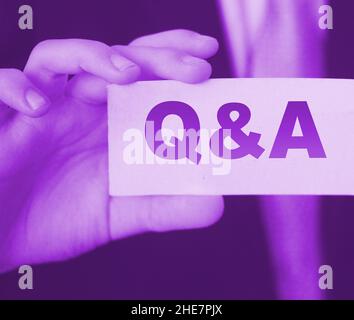 Q and A Questions and Answers sign on business card shown by a businessman,. Business concept. Stock Photo
