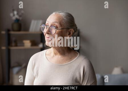 Pleasant smiling middle aged woman visualizing future. Stock Photo