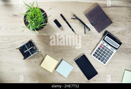 calculator, mobile phone and stationery on the table Stock Photo
