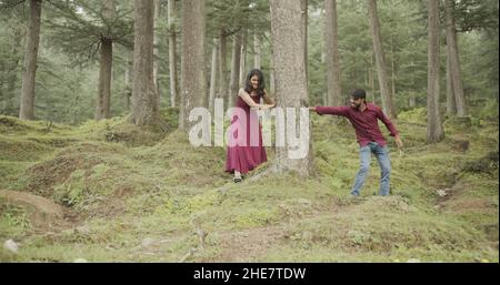 Young Indian couple having a fun while walking during a date at a park Stock Photo
