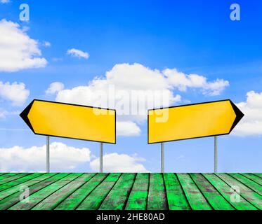 Two street signs with beautiful blue sky with cloud closeup and green wooden flor Stock Photo