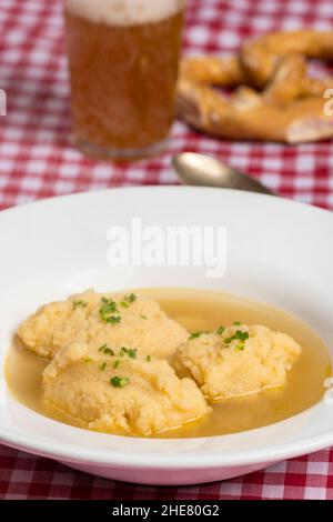 bavarian dumpling soup on tablecloth Stock Photo
