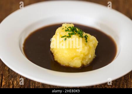 bavarian dumpling in a plate with sauce Stock Photo