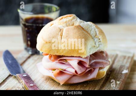 mortadella sandwich on cutting board closeup Stock Photo