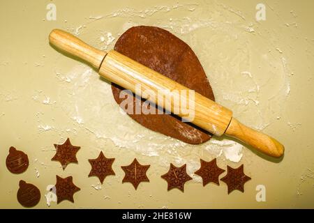 table view of making gingerbread snowflake cookies, gingerbread dough, dough roll Stock Photo