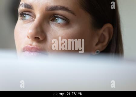 Thoughtful young business woman using laptop computer Stock Photo