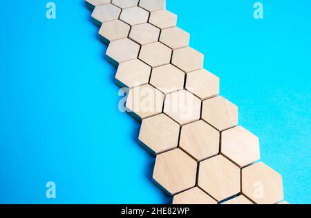 Chain of hexagons on a blue background. Moving forward. Abstraction. Structure, hierarchy. The concept of organization and strength. Unity and Consoli Stock Photo