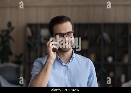 Head shot smiling man in glasses making phone call Stock Photo