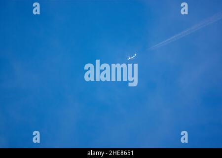 high altitude contrails from a KLM Boeing 787-10 dreamliner en route to JFK New York USA Stock Photo