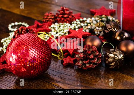Christmas decorations on wooden board. Colorful, gliterry and shiny Christmas decorations. Stock Photo