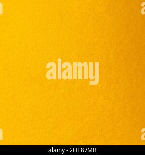 Fragment of dense and hard fabric made of dark yellow synthetic thread Stock Photo
