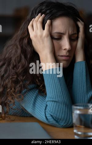 Stressed worried female employee feeling anxious about deadline at workplace. Work anxiety concept Stock Photo
