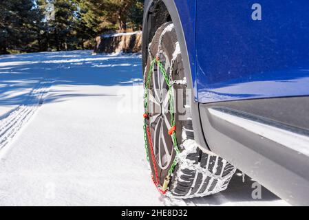 Car wheel with chains and on the snow. Stock Photo
