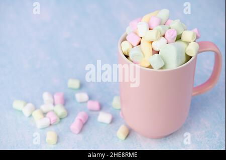 Pink Cup Filled With Marshmallows On Pastel Background With Copy Space Stock Photo