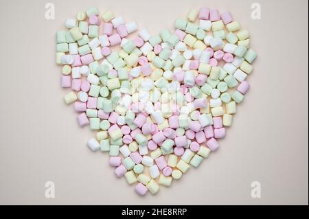 Marshmallows In Bright Colors Lie Heart Shaped On Pastel Background Stock Photo
