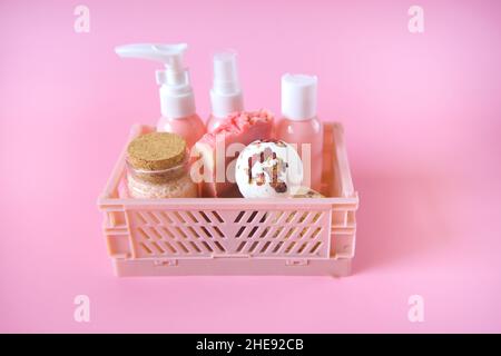 rose extract cosmetics.Bath bombs with rose petals,Pink cosmetic bottles in a pink box on a pink background.Beauty and aromatherapy.  Stock Photo