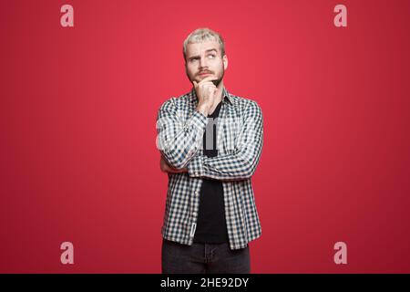 Caucasian man with beard wearing eyeglasses over pink background thinking about a question touch hand chin. Stock Photo