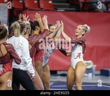 Norman, OK, USA. 9th Jan, 2022. Alabama's Lexi Graber is congratulated by her teammates after her floor routine at the NCAA gymnastics meet between the Alabama Crimson Tide and the Oklahoma Sooners at the Lloyd Noble Center in Norman, OK. Kyle Okita/CSM/Alamy Live News Stock Photo