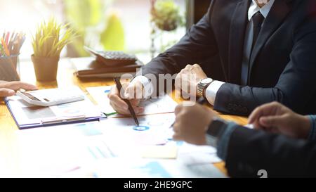 Two of businessmen of financial consultant discussing plans and working on financial data report together at the office. Stock Photo