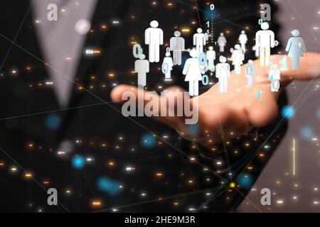 Shallow focus of a human hand holding interconnected  human icons, team networking concept Stock Photo