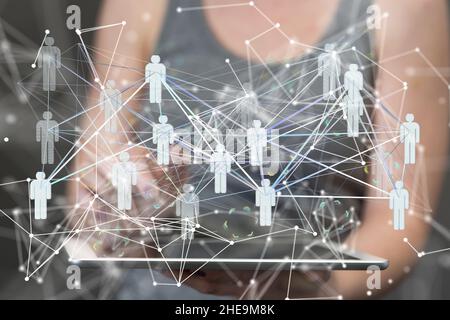 Shallow focus of a human hand holding a tablet with human icons on the air, team networking concept Stock Photo