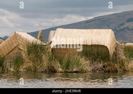 traditional huts made from dry reeds on famous floating Uros Islands at lake Titicaca in Peru Stock Photo