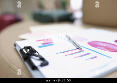 A folder with documents lies on a leather surface Stock Photo