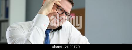 Happy professional employee in cabinet Stock Photo