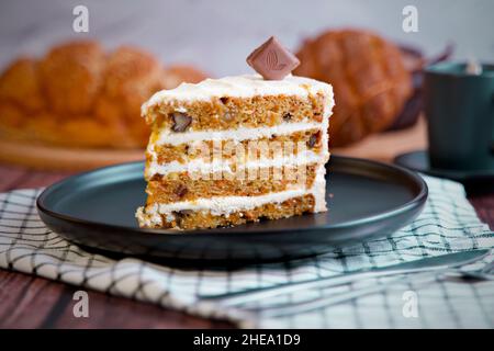Carrot cake slice with cream cheese frosting. Selective focus Stock Photo