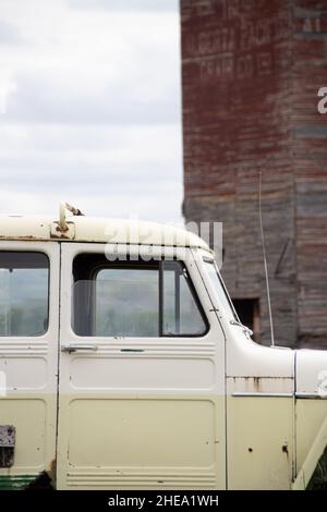 Closeup side shot of an old rusty white truck parked outside Stock Photo