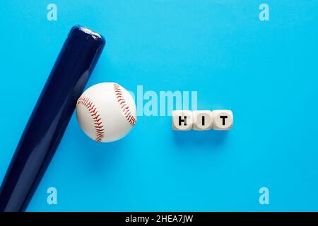 Baseball bat and a ball on blue background with the word hit. Batter ratio in baseball concept. Stock Photo