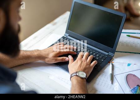 Successful businessman working in the office analyzing business data on notebook Stock Photo