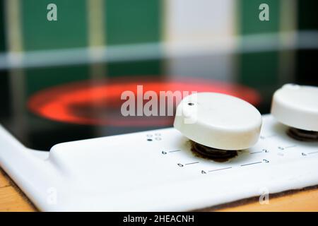 Electric hob in modern home kitchen interior with heat turned up high on oven ring Stock Photo