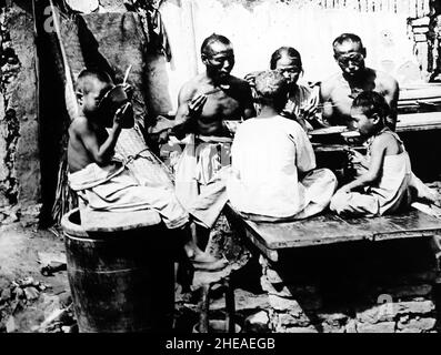 A family eating, China, early 1900s Stock Photo