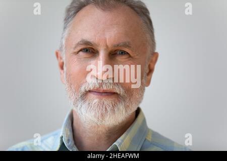 Close up head shot portrait of handsome pleasant mature man. Stock Photo