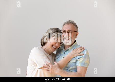 Sincere laughing bonding middle aged couple feeling happy. Stock Photo