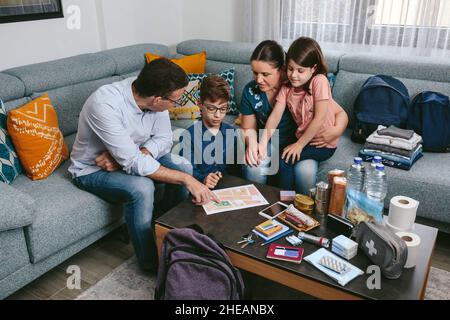 Father explaining to his family the emergency assembly point Stock Photo