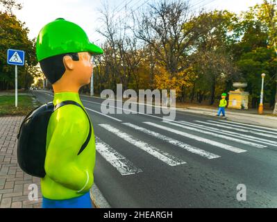Plastic green dummies ; school children by te junction for pedestrians attention. Transnistria roads. Moldova. Stock Photo