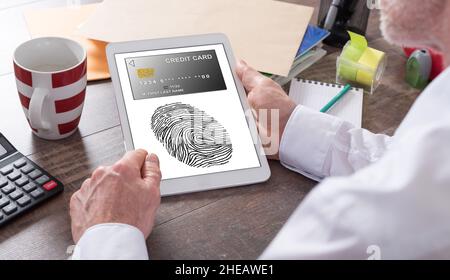 Payment security concept shown on a tablet held by a man Stock Photo