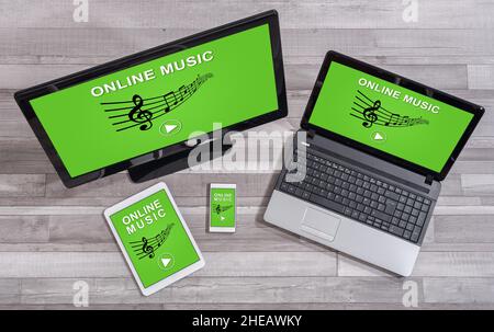 Online music concept shown on different information technology devices Stock Photo